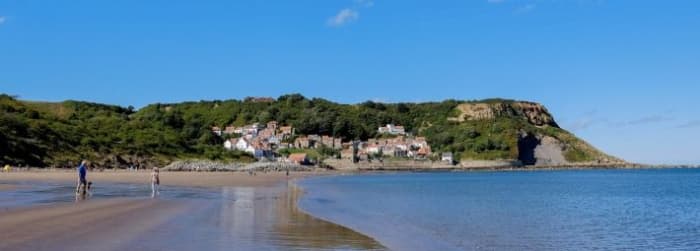 Runswick Bay foreshore at low tide on a sunny summer's afternoon is a welcome sight for paddlers and swimmers - although keep an eye on the flagpost - red flyer means danger for the adventurous, keep to the shallows (Rip tides are fast here)!