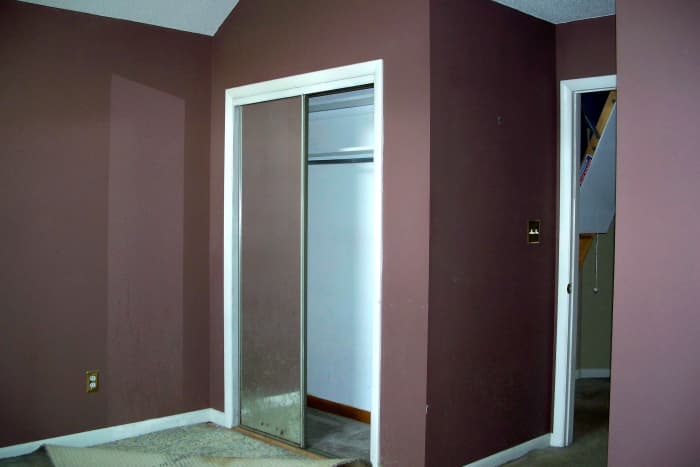 Before: Dark brown walls, carpets ruined by pets and mirrored closet doors needed replacing.