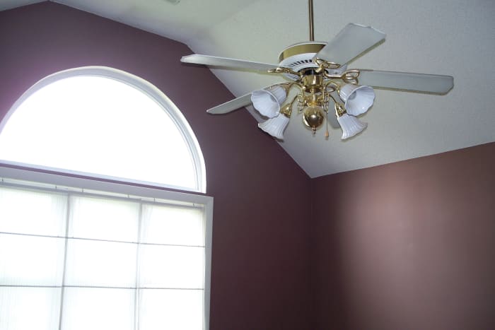 Before: Cathedral ceiling and large arched window are two good points in the master bedroom.