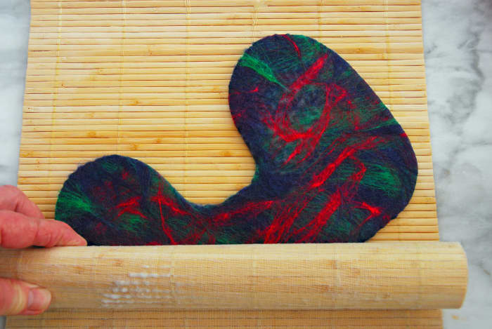 Roll in a Bamboo Mat to complete the fulling process. It helps shrink the fibers further. Keep on changing the direction of the booties