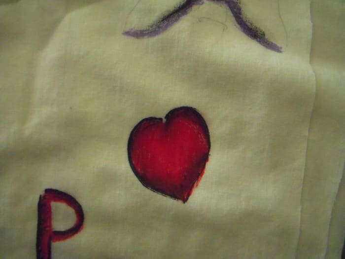 Work on practice fabric first. This is my first blending attempt using black and red. First, I put the black down. Second, the red. I used my finger to blend the colors while they were still wet, moving from the dark edge towards the center of the he