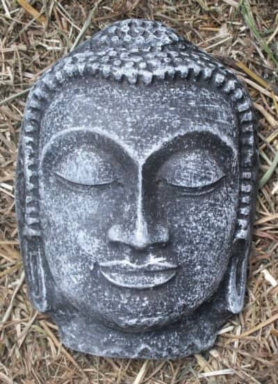 Buddha face painted black-dry brushed green ready to be hung. I put a wire loop, in back before it set.