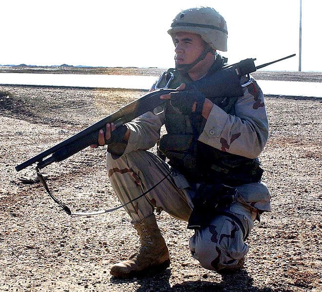 Specialist Freddy Ojeda kneels by a roadside in Al Ramadia, Iraq. Ojeda is assigned to Headquarters Company, 1st Brigade, 1st Infantry Division. If it's good enough for what this guys going to do with it, It's good enough for me!