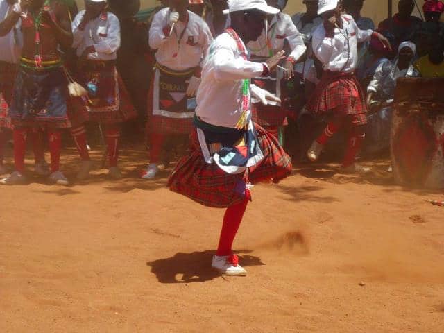 A Mopedi Man in full colorful Bapedi admixture of traditional clothing performing a Pedi traditional dance