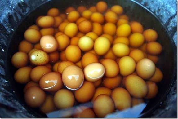 A virgin boy eggs cracked open (top); a young boy peeing in a bucket that will then be used to boil the eggs (middle); eggs simmering in human urine (bottom).
