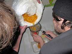 (Top) Making pruno the traditional way by first mashing up ingredients in a bag. (Bottom) Filtering the final concoction of all the rotting ingredients.