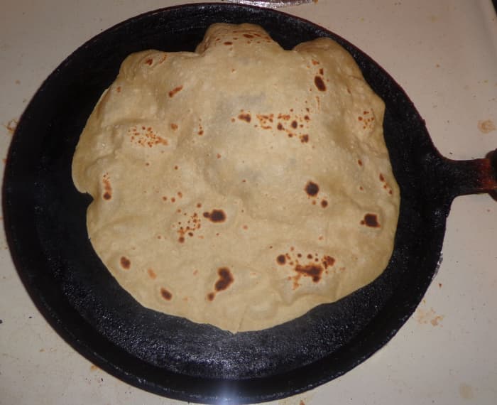 When u press the chapati with a cloth; after flipping it once, you can see the chapati bulging. Now shift the chapati to a separate plate. Your soft home made chapati is ready to serve.