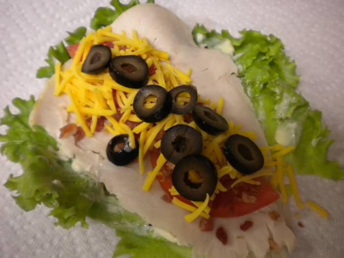 6)Add 2 tbsps grated cheddar cheese. I personally like to add some slices of black olive - it gives it a little more body & bulks your wrap up so you really have something to sink your teeth into.