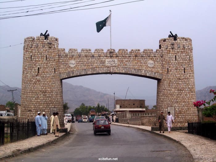 The border crossing between Afghanistan and Pakistan (showing the Pakistan flag) along the world famous Khyber Pass which is also a NATO Supply Route. The Khyber pass also carries the famous Grand Trunk Road which has existed since the 16th Century.