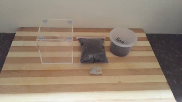 After buying from right to left that's the small bucket i got my sling in, my peat, a rock and a small glass enclosure for my new sling