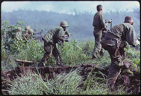 Dak To in South Vietnam. An infantry patrol moves up to assault a Viet Cong position after an attempted overrun of the artillery position by the Viet Cong during Operation Hawthorne.