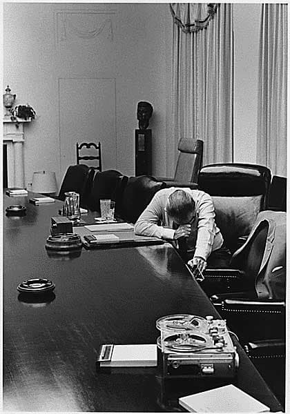 1964 - President Lyndon B. Johnson listens to taped report sent by adviser Captain Charles Robb (his future son-in-law) from Vietnam.