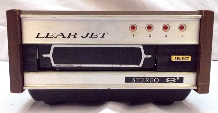 The Lear Jet 8-Track Stereo Player Model HSA-940 with a wood case, 12 volts, 35 Watts, and one of the first 8 track tape players ever made.