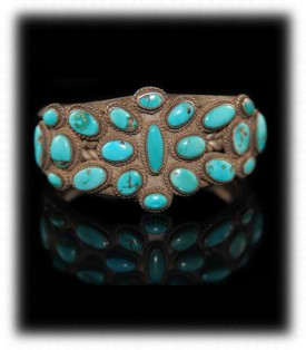 Vintage/antique Navajo turquoise cluster bracelet made around 1920 from silver coins. This has been a very popular style from 1900 to present although today the bracelet would be made of sterling silver.