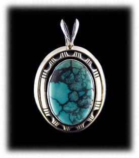 Blue spider web turquoise surrounded by stamped sterling silver. Spider web turquoise is very popular today.