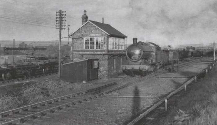 Unidentified Class Q6 0-8-0 brings a train of mineral wagons past Crag Hall signal cabin between Skinningrove Works and the Whitby-Loftus road