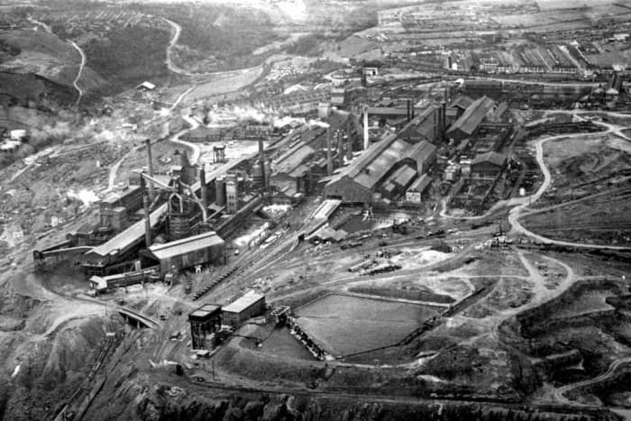 South-east of Teesside is (still) Skinningrove Iron & Steel Works. To the left is Skinningrove village ('Shining Grove') with its former ironstone drift mine. Top left the zig-zag road leads uphill to the village of Carlin How and Loftus beyond