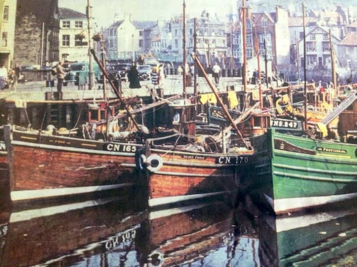 Whitby 1950s. In the 19th Century the harbour filled with herring boats from Scotland. Whitby trawlers now range out ihto the Atlantic for their catches. Inshore fishing vessels bring in coastal catches and timber vessels still come from the Baltic