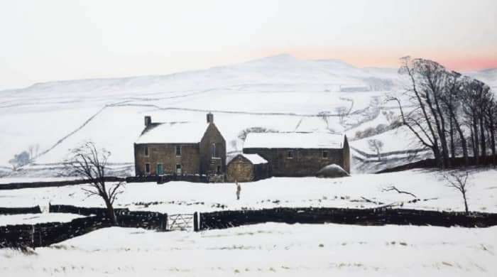 Low Birk Hatt, the farmhouse- left - and outbuildings set against a wintry sub-Pennine sky over Baldersdale