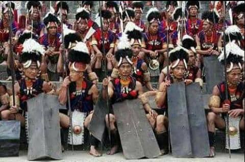 A group of cultural troupe With their shields, spears and adorned with traditional attire, before the folk dance begins at hornbill festival in Kohima.