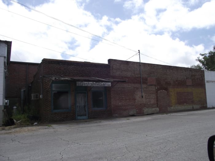 This is part of Walker Street in New Houlka. You can see where window and a door were once located on the building on the right.