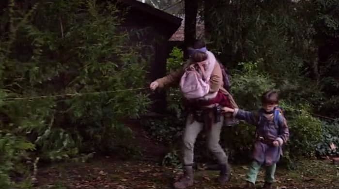 Malorie carries Girl and guides Boy along the path to the riverbank in 'Bird Box' (2018), a Netflix Original.