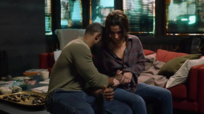 Tom (Trevante Rhodes) and Malorie (Sandra Bullock) share a special moment in 'Bird Box' (2018), a Netflix Original.