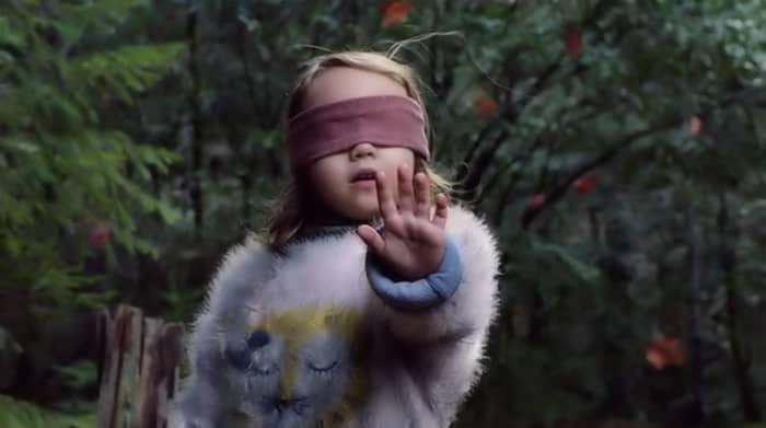 Leaves swirl and Girl's (Vivien Lyra Blair) hair stands on end as the creatures draws near in 'Bird Box' (2018), a Netflix Original.
