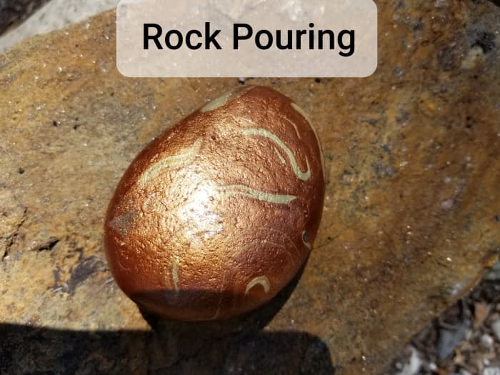 Pour a few colors of paint in small cups from the dollar store then in a larger cup drip a drop or two in layers. Finish by pouring on a clean, smooth rock.