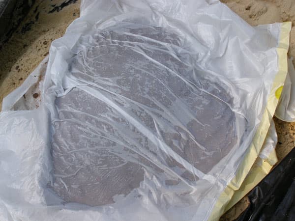 After all the concrete is smoothly applied, cover the top and sides with plastic to cure and dry for at least 24 hours.