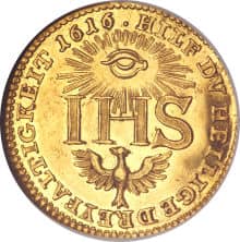 A gold coin with the all-seeing eye in the sun, and a Phoenix rising out of the ashes and the IHS. 1616 Saxon (German) Ducat.