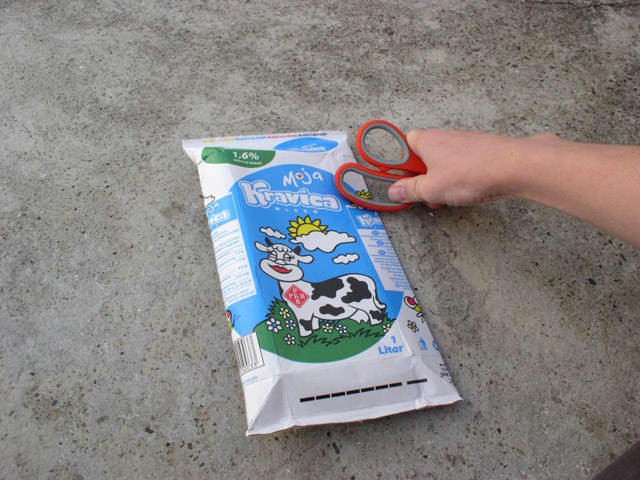 Press the scissors down on the package and then move along the fold while keeping the pressure on the scissors.