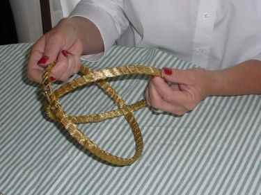Step 1: Time to fit the two embroidery hoops together, to create the mobile, and the setting for your centerpiece decoration. The embroidery hoop with the screw will be the top hoop, fit the slightly smaller hoop into the hoop with the screw.