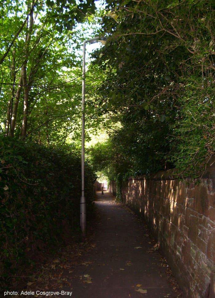 A quiet lane leading from Ashton Park to Grange Road. Either turn left to arrive back at the train station, or cross the road to Darmond's Green.