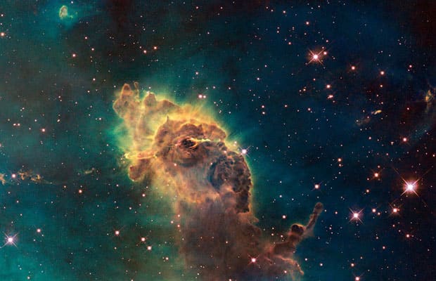 Hubble's first images of visible image of the Carina Nebula. It is composed of gas and dust and the pictured pillar resides in the tempestuous stellar nursery in the Carina Nebula, located 7500 light years in the southern constellation of Carina. Thi