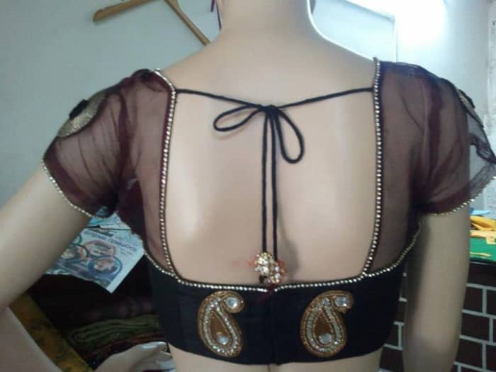 This sexy black blouse is made of black tissue material and black Indian Khaadi with a square neck blouse design.