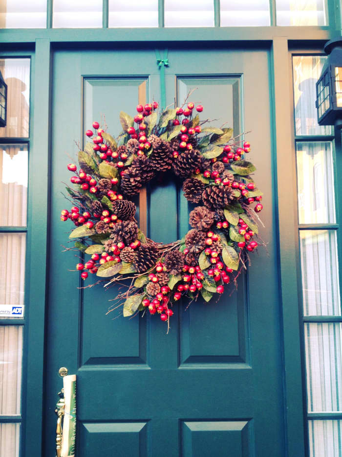 A berry wreath for the front door adds a festive touch and is perfect for holiday decor.