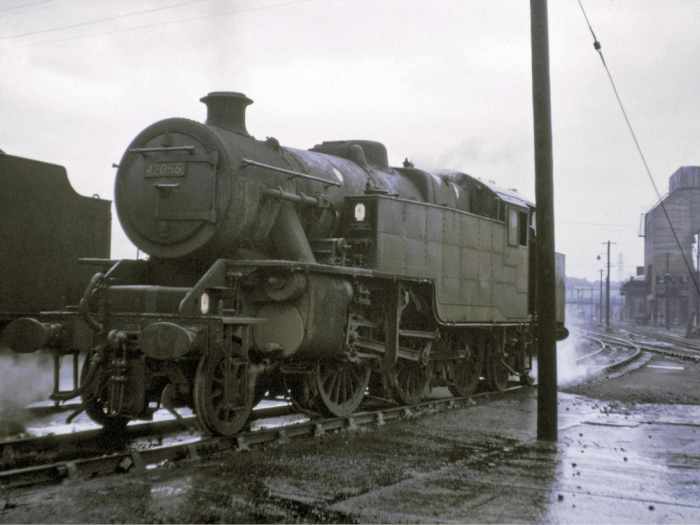 42055 stands in the rain at Low Moor shed near Bradford. An atmospheric shot of a redoubtable locomotive