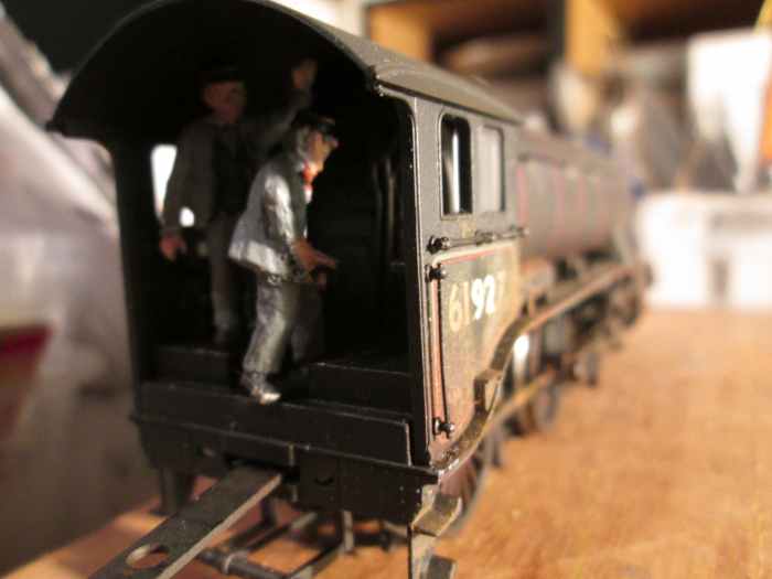 In the cab, the fireman busies himself with feeding the grate whilst the driver keeps a firm grip on the regulator