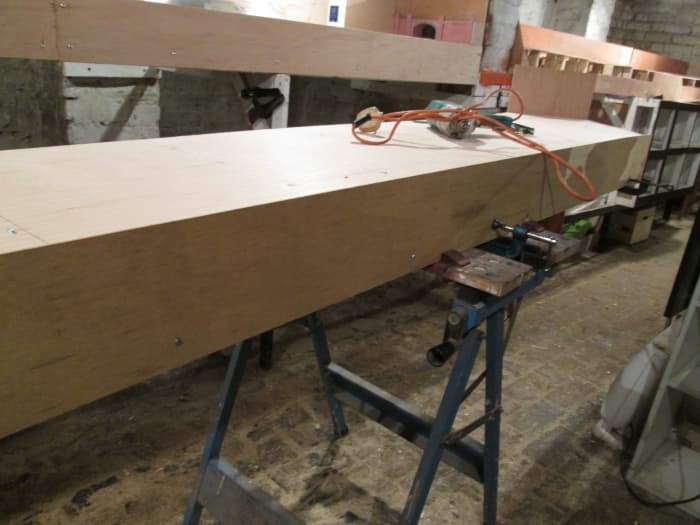 Front panel attached to Unit 7, 5.5 inches deep 4mm ply with nine .75 inch cheese-head slotted screws (2 each end),