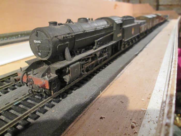 Three-quarter view of WD 2-8-0 90446 of Newport (near Middlesbrough) shed, 51B heads a mixed fitted and unfitted working from the lower deck fiddleyard
