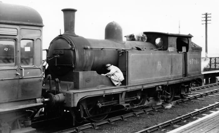 G5 in BR days - 67282 of Hull Botanic Gardens shed (53B) rests possibly at Hornsea, before returning to Hull whilst driver inspects the loco - trouble?