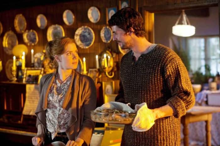 Declan bringing his cooking into the dining room after Anna sets the table in the couple's home that has a room for them. Scene from the movie "Leap Year".