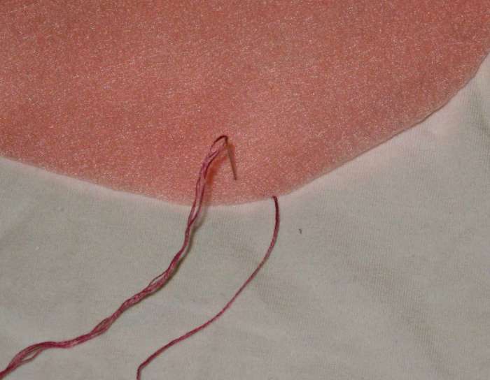 Blanket Stitch, steps 1 & 2: Bring thread out at edge of circle. Go back in a quarter-inch from the edge.