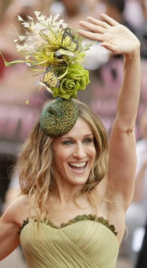Sarah Jessica Parker waves to get attention, just in case no-one noticed her crazy olive green floral hat
