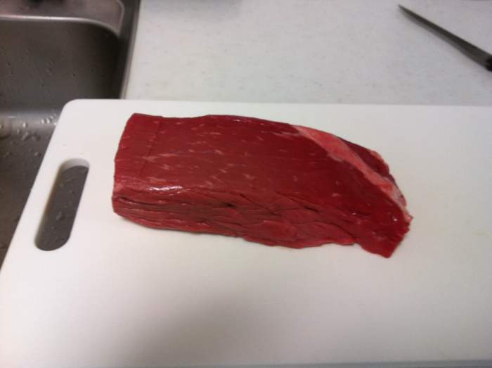 A slab of beef ready to be cut into strips before being made into beef biltong.