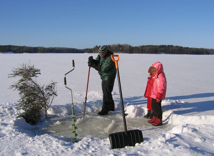 Cutting a hole in the ice when the lake is frozen.