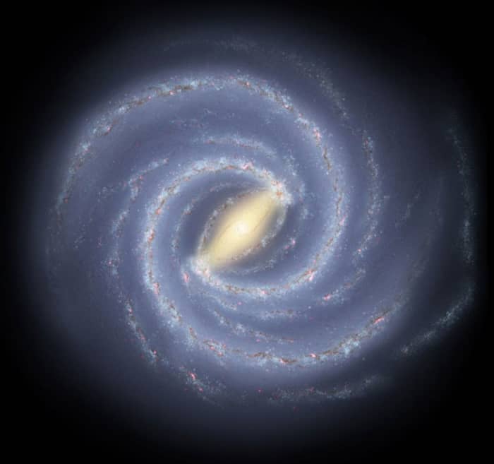 In this artist rendition we can see the milky way galaxy. Below the center and approximately four spiral arms outward, lie the sun and our solar system. Or approximately 25,000 light years from the core of the milky way