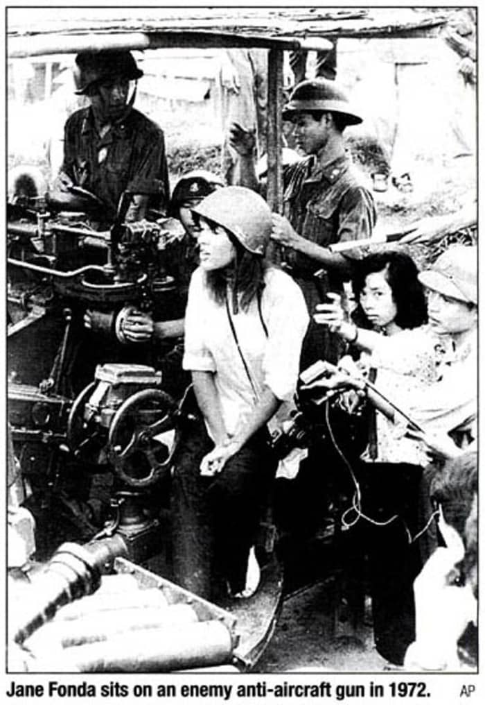 JANE FONDA PROVIDING COMMUNISTS WITH PROPAGANDA PHOTO SITTING ON COMMUNIST ANTI-AIRCRAFT GUN USED TO KILL AMERICAN PILOTS