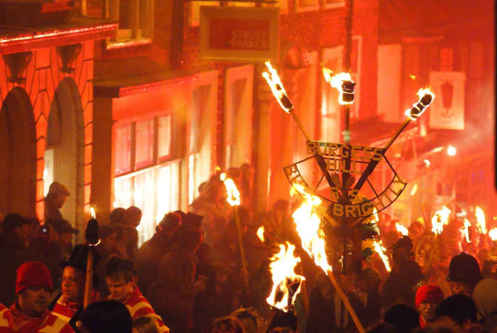 On Bonfire Night, revelers celebrate in the streets, watch fireworks, light bonfires, and burn effigies of Guy Fawkes.